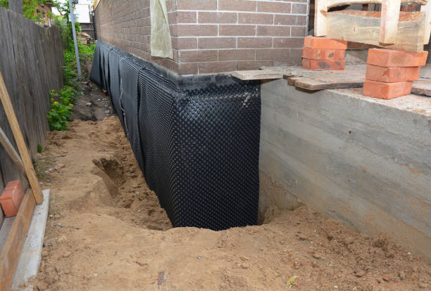 SJ Waterproofing Pros technician performing targeted Wet Basement Repair assessment in Raymond, OH